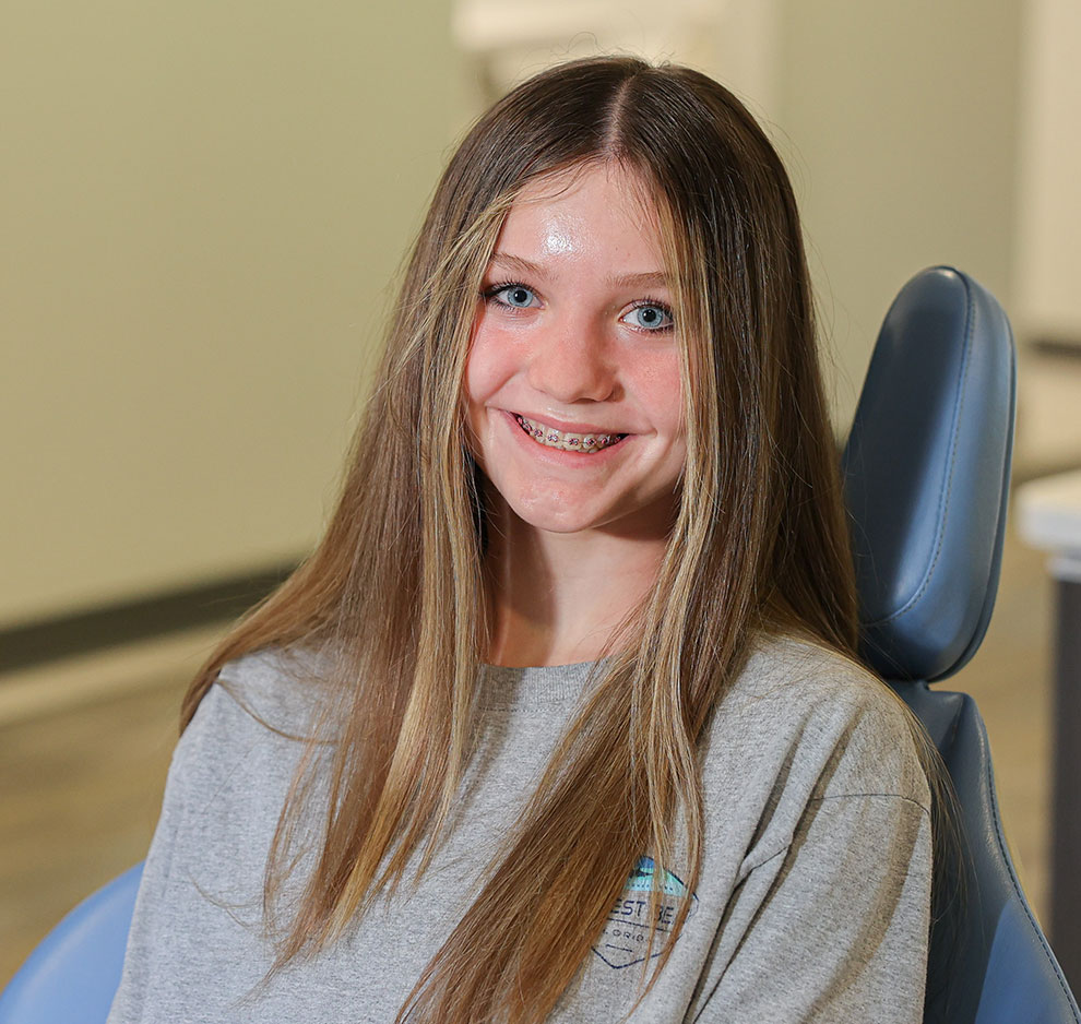 Young girl smiling in dental chair at pediatric dental office